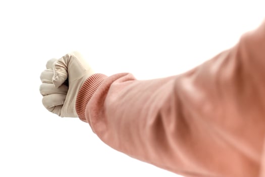 A protective gloved fist isolated on white, symbolizing safety and cleanliness, with focus on healthcare and hygiene practices. photo