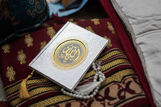 Holy Al Quran with written arabic calligraphy meaning of Al Quran photo
