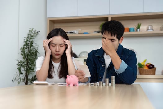 Couple Facing Financial Stress. Young adults looking worried while reviewing finances. photo