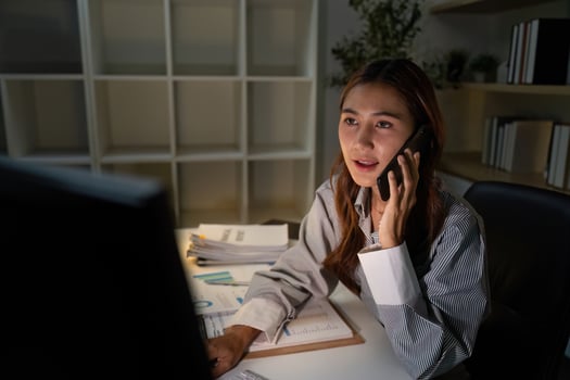 Late Night Communication. Professional woman on phone discussing financial matters. photo