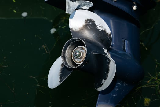 Close-up of boat propeller in water with algae photo