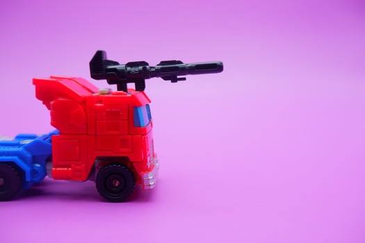 Red and Blue Toy Truck with Weapon Attachment photo