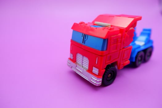 Miniature Action Truck on Vibrant Pink Surface photo