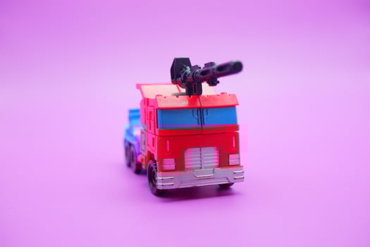 Colorful Plastic Toy Truck with Gun on Top photo