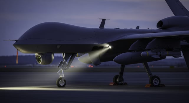 Modern military drone on airfield at dusk with landing lights on photo