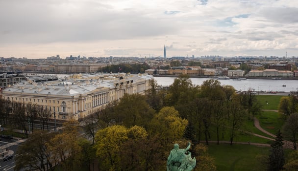 Skyline View of St. Petersburg With Green Parks and River at Dusk Highlighting the Citys Historic Architecture and Modern Structures photo