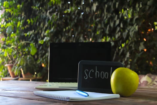 Back to school concept.There is a laptop and a school sign on the table. photo