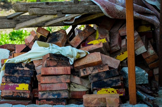 A pile of bricks and a white cloth. The bricks are stacked on top of each other and the cloth is on top of the bricks photo