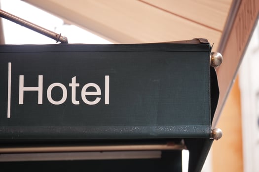 Hotel entrance sign at a busy city location in daylight photo