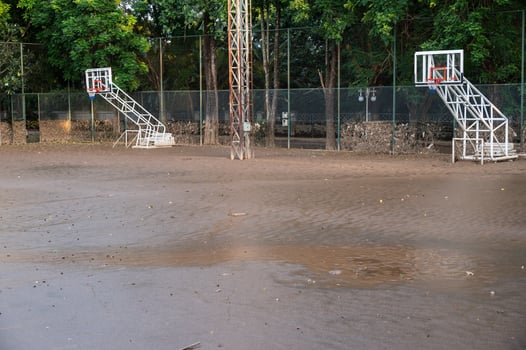 Basketball court having damaged and mud flooded after Kok river rising and flooding Chiang Rai province, Thailand. photo
