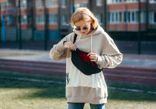 Adult model girl with waist bag, street photo. photo