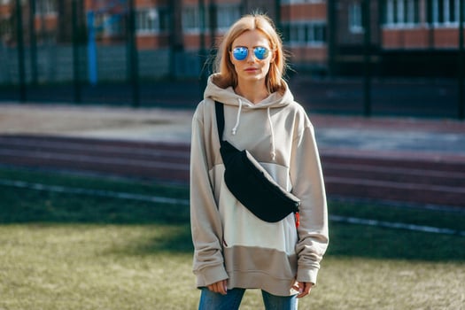 Blonde model girl with waist bag, street photo. photo