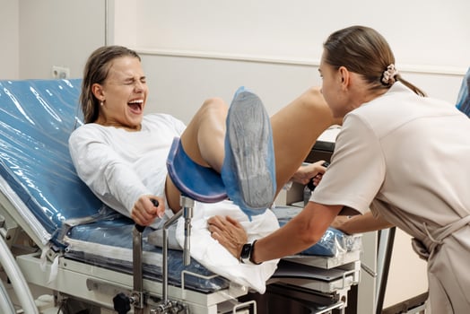 Midwife assisting a woman during labor. Concept of professional pregnancy care and emotional support photo