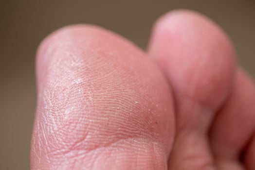 Close-up action of human hand skin texture indoor setting macro detailed view touch sensation photo