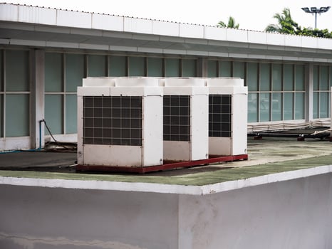 Industrial air conditioning units rooftop urban environment overcast sky photo