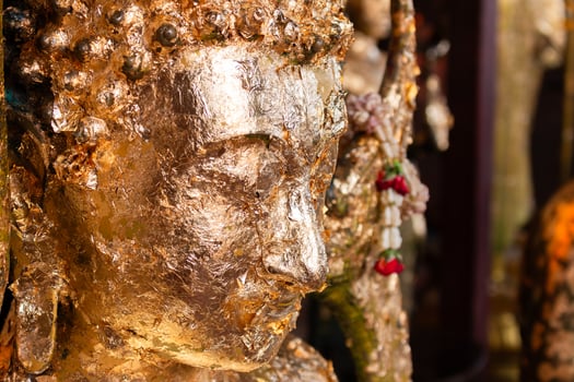 Artistic close-up of buddha sculpture spiritual symbolism in thailand's serene temple atmosphere photo