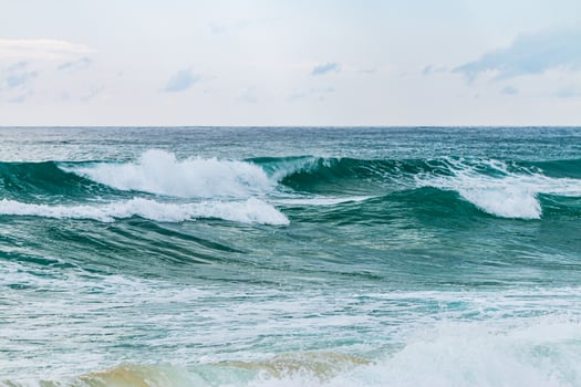 Waves crashing the shore coastal beach ocean serene environment wide view nature's beauty photo