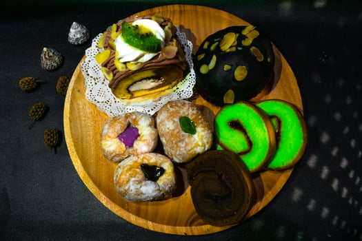 A wooden plate topped with various pastries and other desserts photo