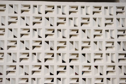 Geometric white wall pattern design with repeating square blocks and interior shadows for photo