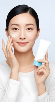 Radiant Asian Woman Applies Moisturizer, Embracing a Natural Beauty Ritual, A Serene Portrait of Skincare Confidence and Self Care photo