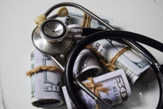 Stethoscope and dollar currency on white table. healthcare or Medical concept photo