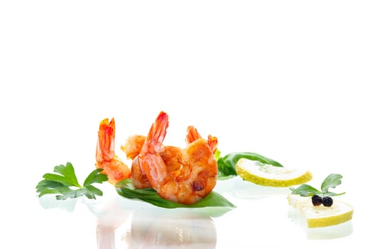 Delicious sea shrimps with lemon isolated on white photo