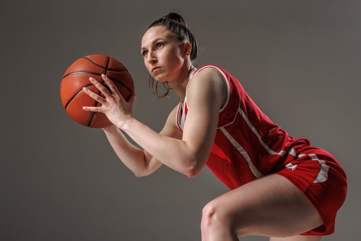 Focused Female Basketball Player in Action, Preparing to Shoot during Professional Training photo