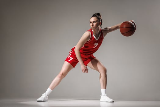 Female Basketball Player in Red Uniform Dribbling during Professional Training and Competition photo