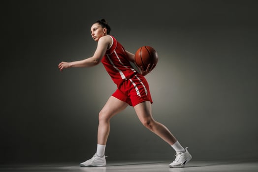 Female Basketball Player in Action during Training in Red Uniform, Studio Shot for Sports Promotion photo