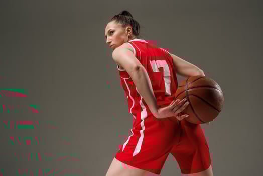 Female Basketball Player in Red Jersey Ready for Action during Professional Sports Training photo