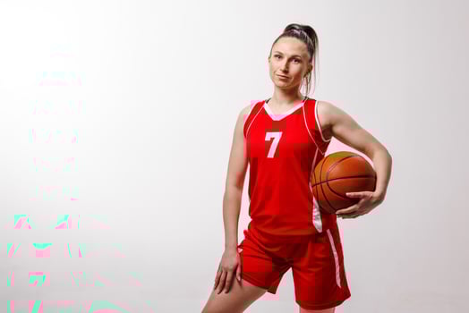 Young woman basketball player in sports uniform ready for lesson, professional training or competition, symbolizing strength and confidence. photo