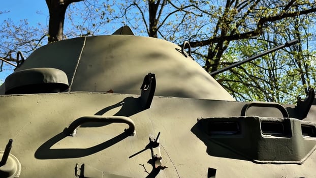 A military tank is showcased in a lush green backdrop emphasising its design, functionality, and aesthetics photo