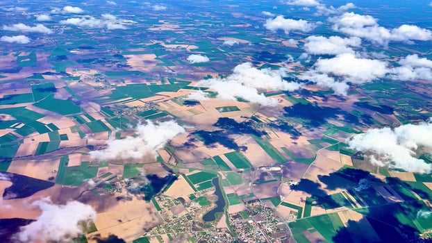 An incredibly stunning aerial view showcasing diverse agricultural fields that spread beautifully under a bright sky photo