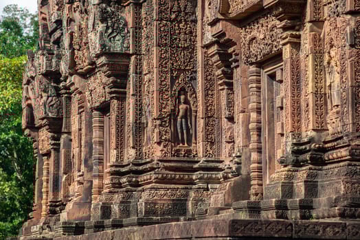 Beautiful bas relief in Banteay Srei a 10th century Cambodian temple dedicated to the Hindu god Shiva made by pink and red sandstone in Siem Reap, Cambodia. photo