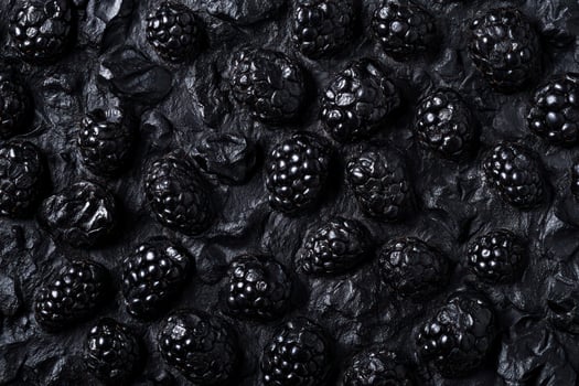 Blackberries on dark stone photo