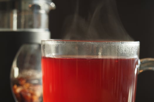 Brewing a warm cup of herbal tea in a cozy kitchen setting photo