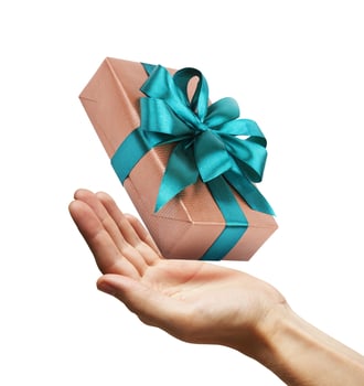 Gift box with ribbon in a hand photo