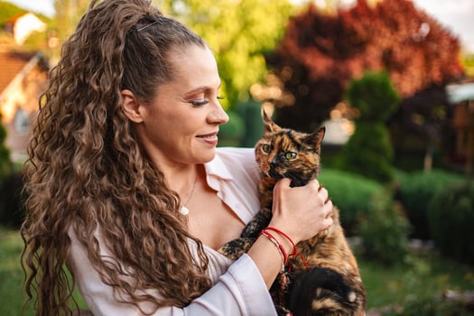 Woman enjoys a sunny afternoon with her adorable cat photo
