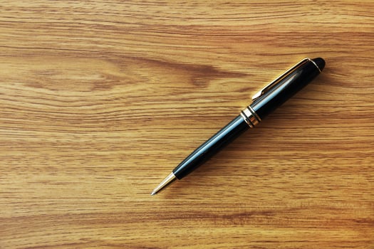 one black business pen on wood background photo