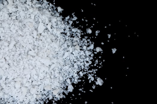 white sea salt isolated on black photo