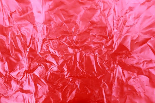 red wrinkled plastic texture background photo