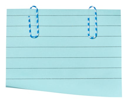 A rectangular sheet of light blue lined paper with two blue and white striped paper clips attached to the top. photo