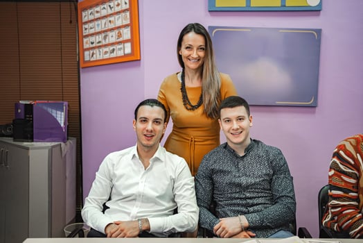 Teacher with two male students at language school photo