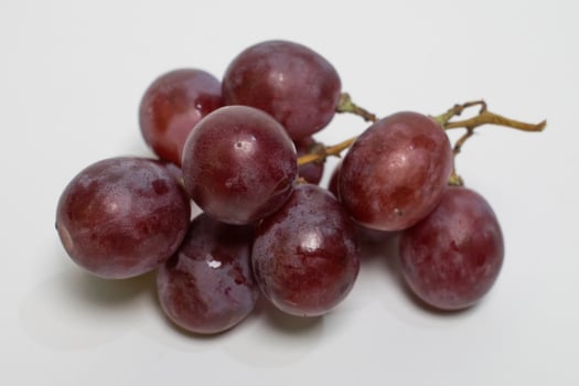 A tight cluster of sweet grapes placed on a white background. photo