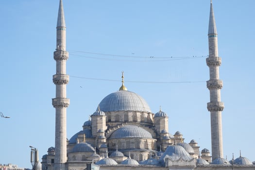 Beautiful mosque with minarets under clear blue sky photo