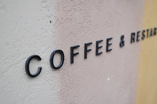 Coffee and restaurant sign on a textured wall photo