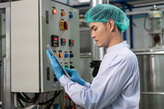 quality supervisor or food or beverages technician discuss about process control of food and drugs before send product to the customer. Production leader recheck ingredient photo