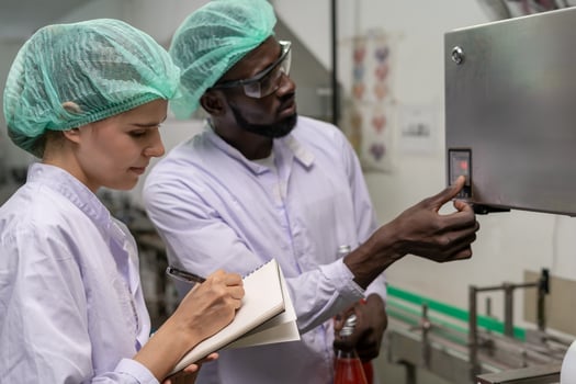 quality supervisor or food or pharmaceutical technician discuss about process control of food and drugs before send product to the customer. Production leader recheck parameter. photo