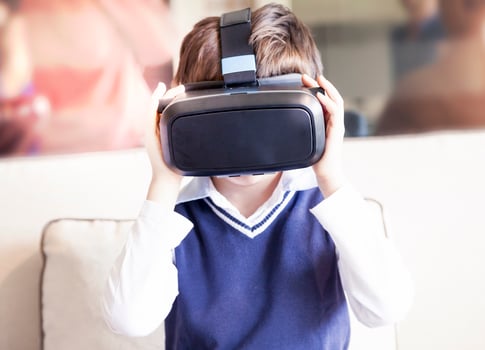 child lives the experience of virtual reality at home photo