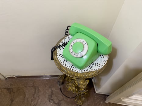 An old green phone is sitting on a gold stand. USSR phone. copy space, top view photo